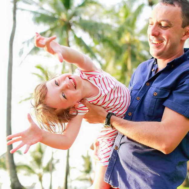 funny girl playing with her dad. Family photo shooting by Krabi family photographer